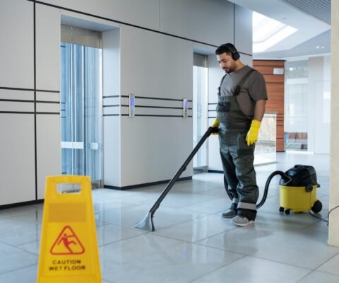 full-shot-man-vacuuming-floor