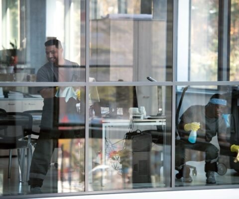 full-shot-smiley-man-cleaning-window (1)